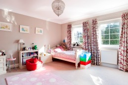 Pre teen girl's bedroom neptune styled with light curtains and girlish design. Soft toys, bookshelves, drawers and large window. Location hire for TV and filming in Park Lodge, London