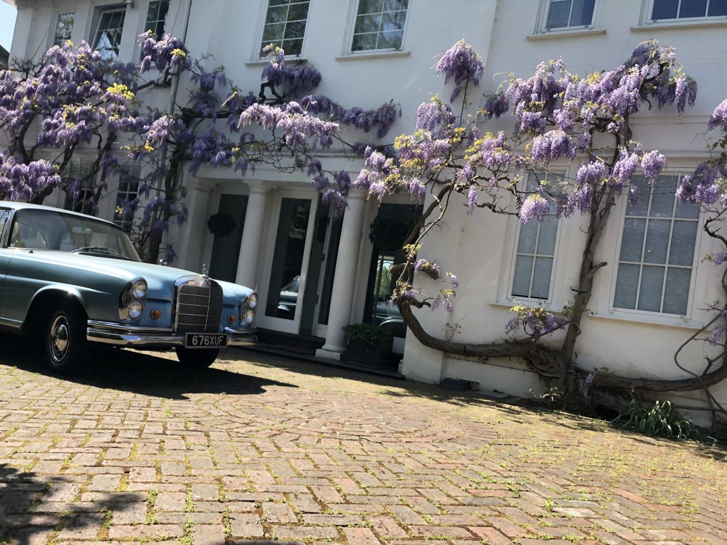 Classic car in wisteria driveway for TV and filming location hire in Park Lodge, London