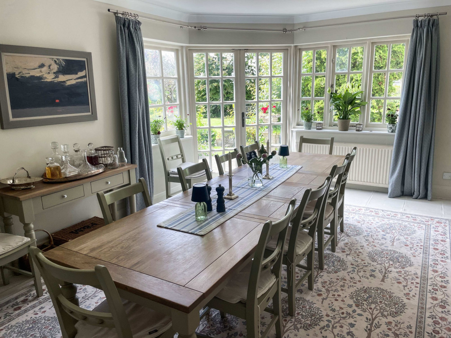 Dining-room-oak-table-paintings-windows-garden-view-fireplace-cabinet-carpet-TV-filming-location-hire-lodge-London