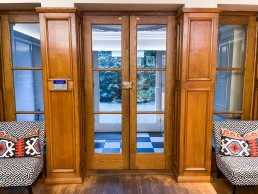 Entrance hall with large acorn glass doors with wood panels. Location hire for TV and filming in Park Lodge, London