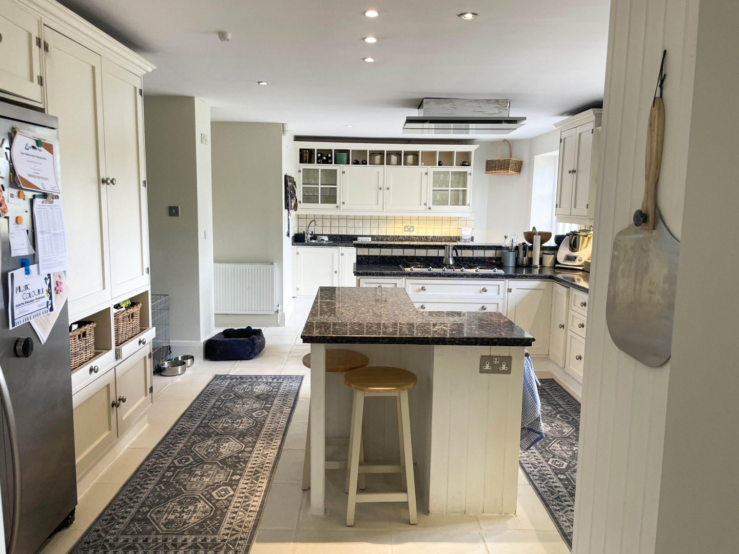 Kitchen-thru-dining-white-tile-floor-white-cooker-marble-worktops-runner-TV-filming-location-hire-lodge-London