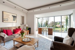 Large sitting room with oak desk and marble floor with bifold glass window. Location hire for TV and filming in Park Lodge, London
