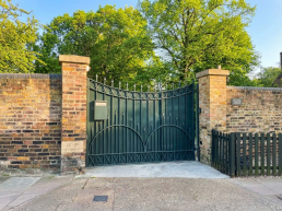 London film location North Lodge Hire for filming, TV, commercial, photoshoots, Luxury property London homes London real estate gated area entrance.