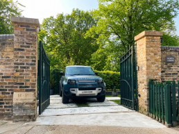 London film location North Lodge Hire for filming, TV, commercial, photoshoots, Luxury property London homes London real estate gated area entrance, driveway range rover.