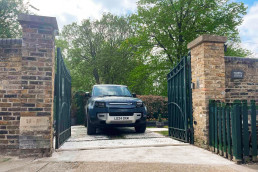 London film location North Lodge Hire for filming, TV, commercial, photoshoots, Luxury property London homes London real estate gated area entrance, driveway range rover.