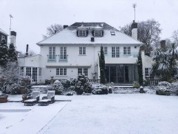 Beautiful rear garden in winter, trees covered in snow. Location hire for TV and filming in Park Lodge, London
