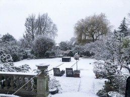 Beautiful rear garden in winter, trees covered in snow. Location hire for TV and filming in Park Lodge, London