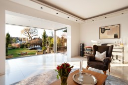 Sitting room with a garden view, glass door, work table and marble floor. Location hire for TV and filming in Park Lodge, London