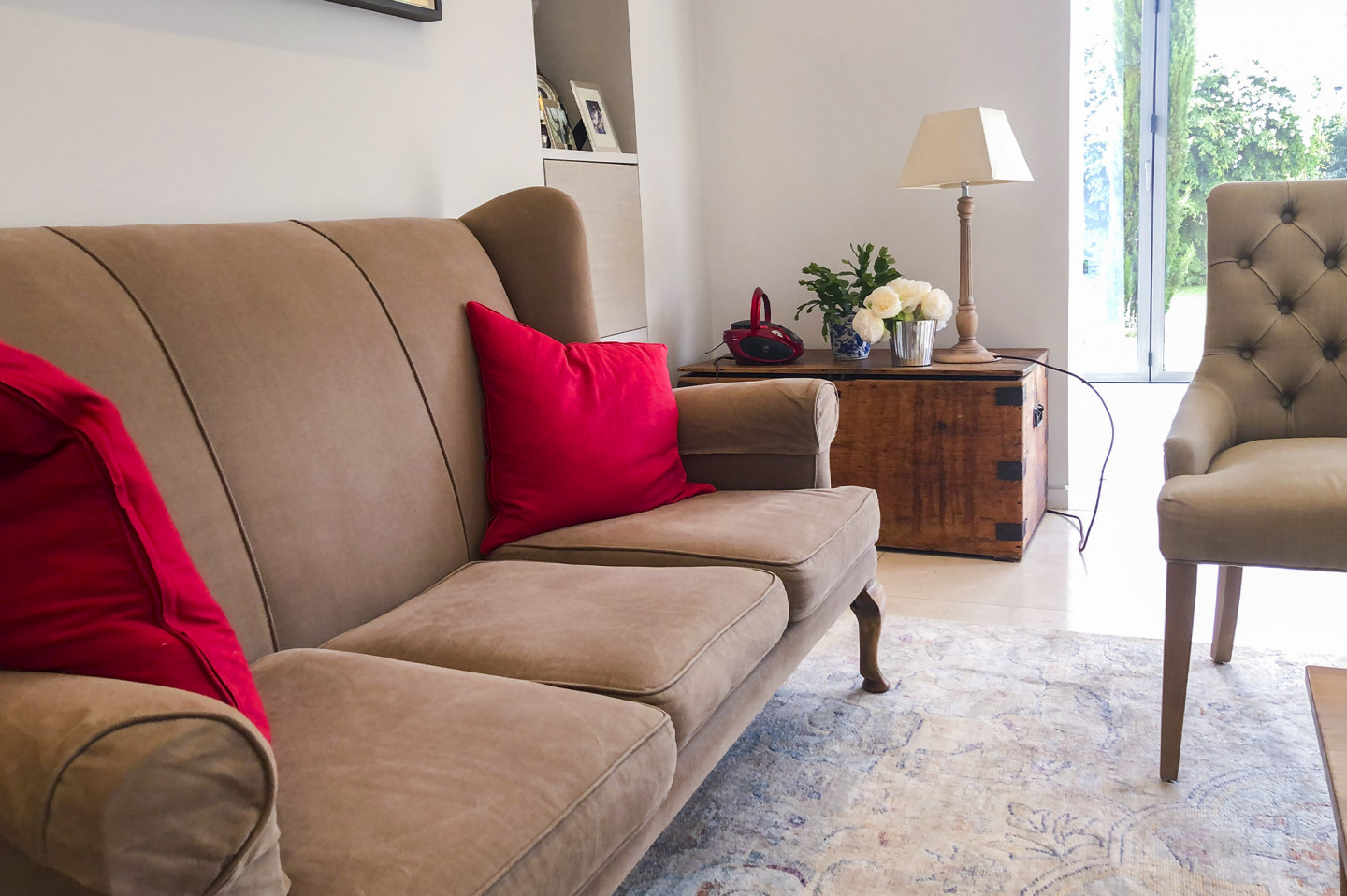 Sitting room with a garden view, modern art on wall, beige sofa and chairs. Location hire for TV and filming in Park Lodge, London
