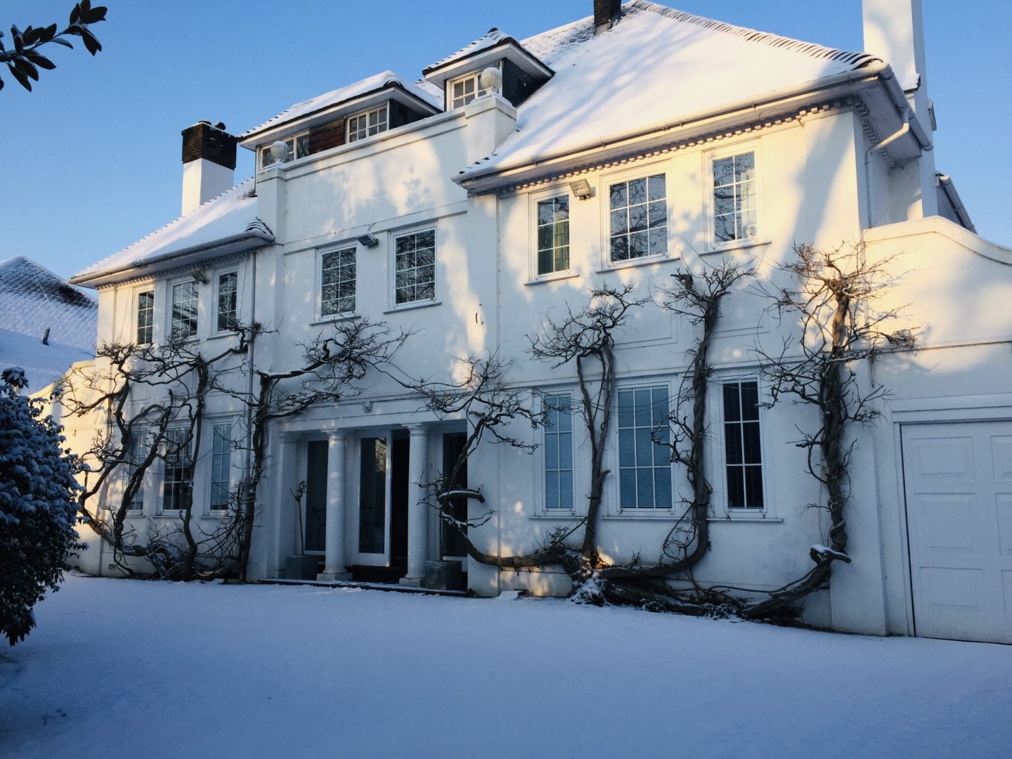 Classic car in snowy winter driveway for TV and filming location hire in Park Lodge, London